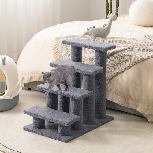 Gray cat tree with a cat climbing on it in a bedroom setting