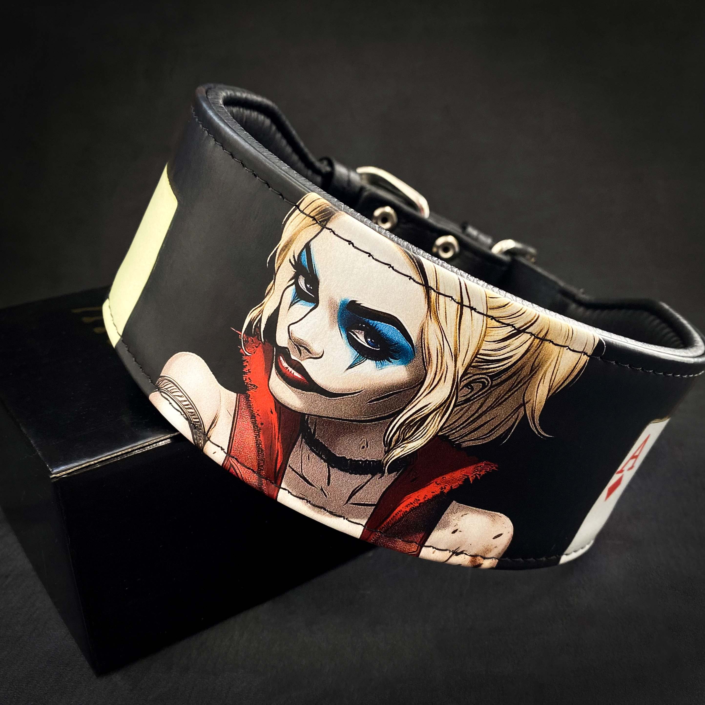 Leather wristband with a graphic design of a character on a black background