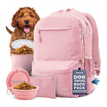 Pink dog travel backpack with bowls of dog food and a dog on a white background