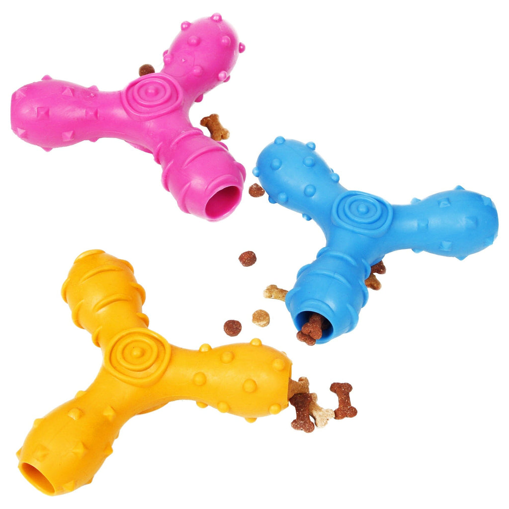 Three colorful dog toys shaped like a letter 'T' with small treats on a white background